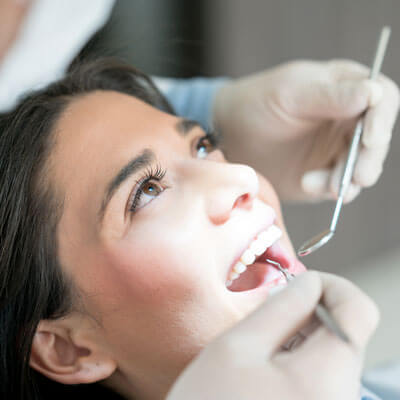 Patient being examined ahead of dental implant crown treatment